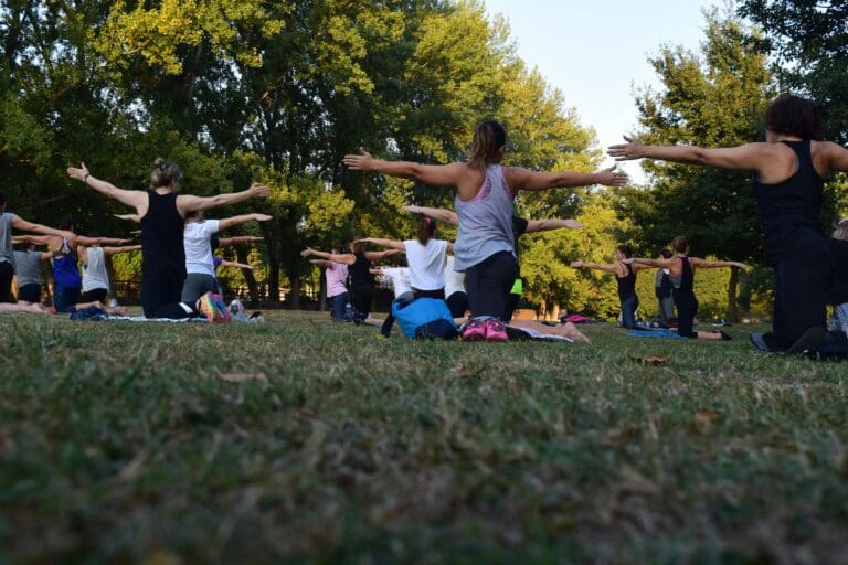 a group of people doin yoga outdoor